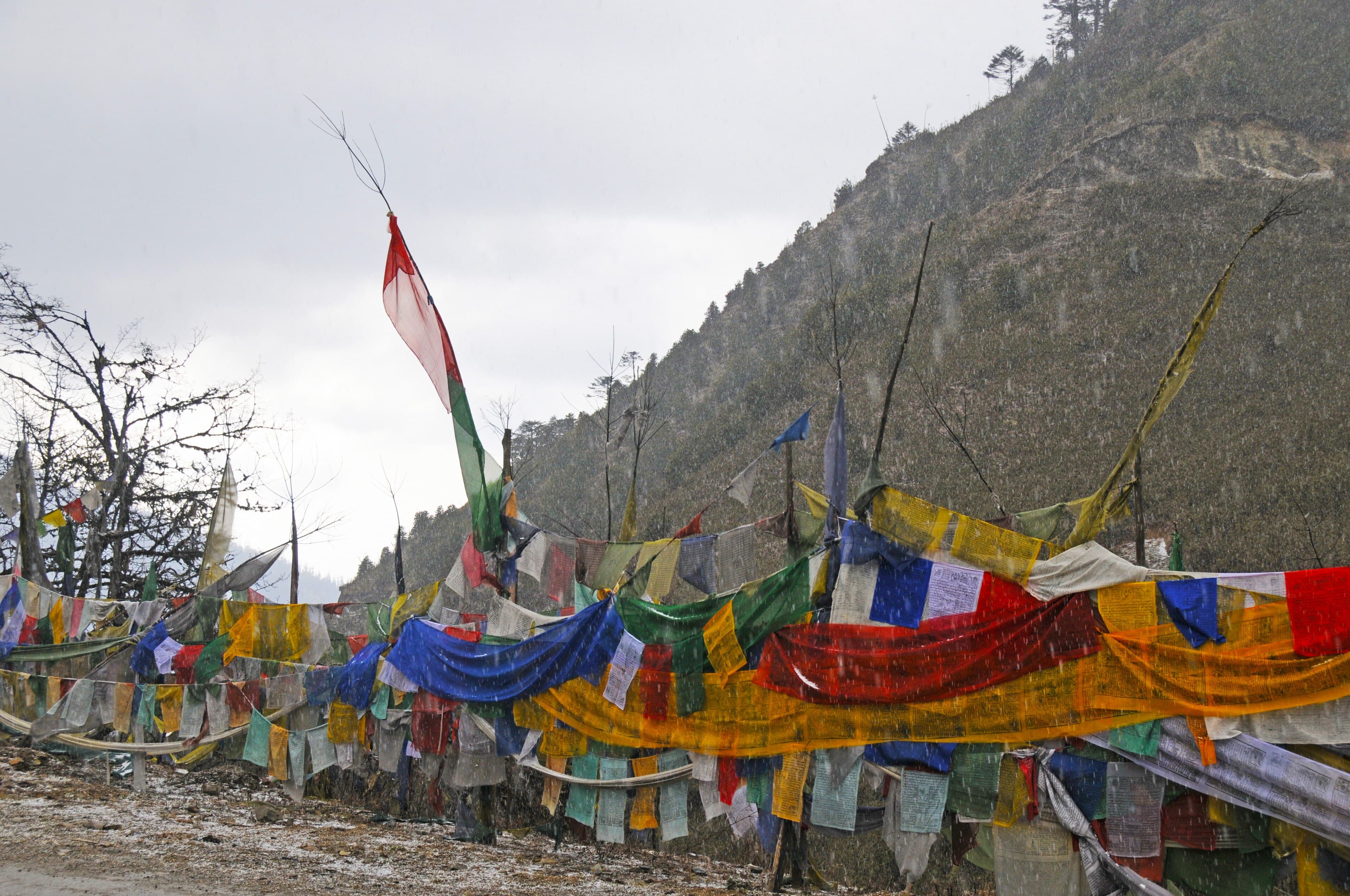 Prayer flags on a high Bhutanese pass (stand-in photo for Yotong La)